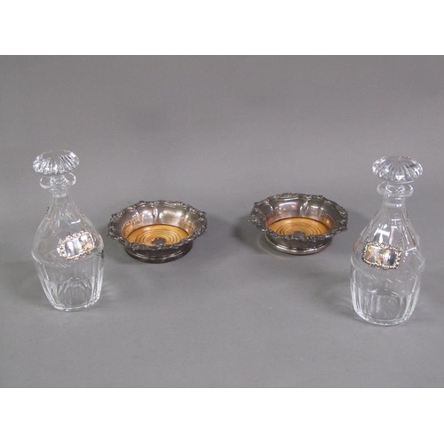 209 - A pair of 19c cut glass decanters with silver labels, together with a pair of Sheffield plated coast... 