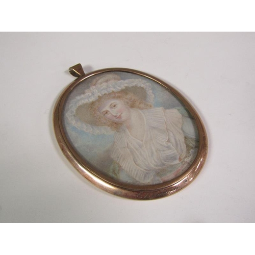 94 - A 9ct gold framed oval portrait miniature of a lady with red hair wearing a wide brimmed feathered h... 