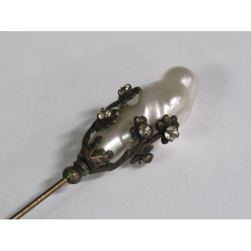 110 - A late 19c Art Nouveau style silver hat pin with a swirl terminal together with one baroque pearl.