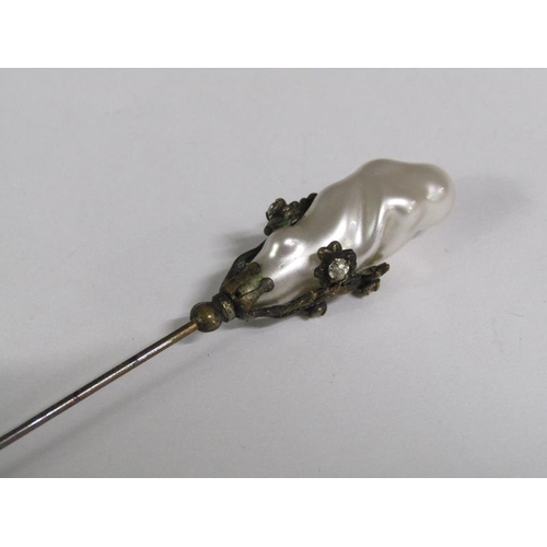 110 - A late 19c Art Nouveau style silver hat pin with a swirl terminal together with one baroque pearl.