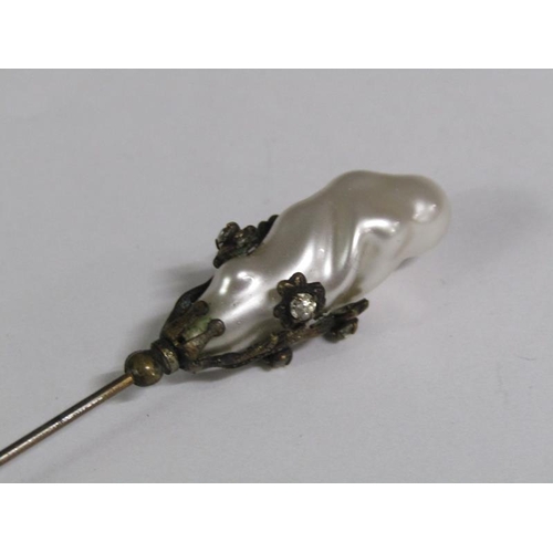 110 - A late 19c Art Nouveau style silver hat pin with a swirl terminal together with one baroque pearl.