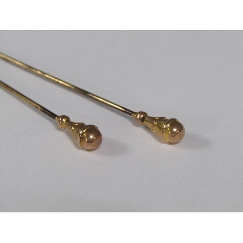 111 - Four Edwardian hat pins each with gold terminals, two being a pair.