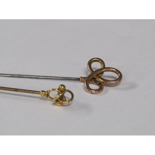 112 - A pair of Art Nouveau hat pins with gold swirling terminals.