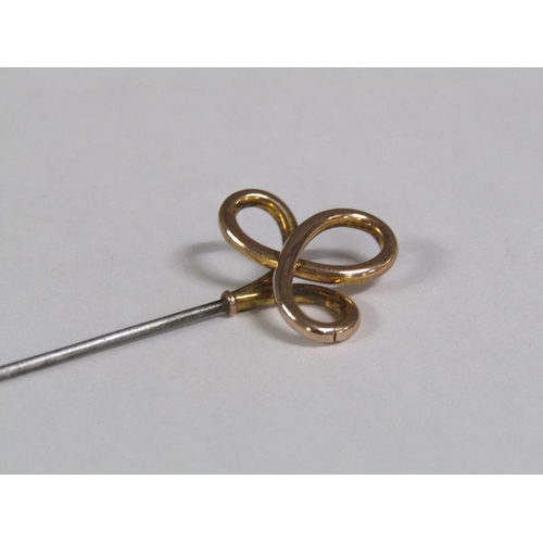 112 - A pair of Art Nouveau hat pins with gold swirling terminals.