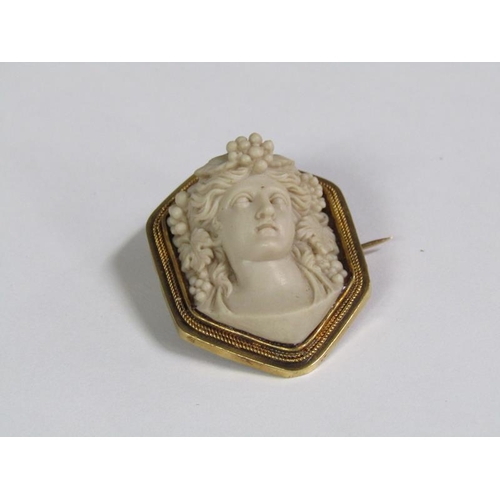 116 - A Victorian gold lava brooch in a pinchbeck setting carved as a classical lady with fruit in her hai... 