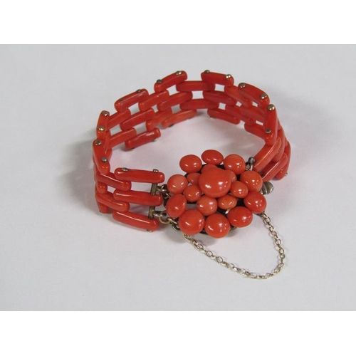 117 - An Edwardian coral bracelet, the bracelet of linked gate design with a bud beaded clasp mount.