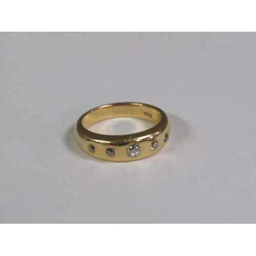 118 - An 18ct gold ring set with five cut diamonds, 9.5g.