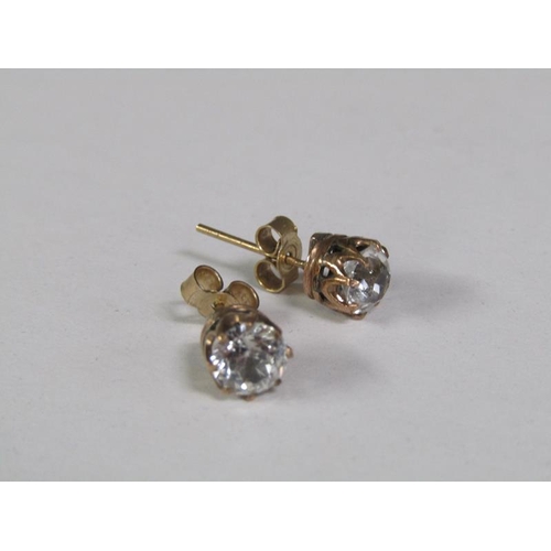 123 - A pair of gold ear studs, each coronet set with a cut diamond, each approx. 0.5ct.