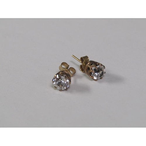 123 - A pair of gold ear studs, each coronet set with a cut diamond, each approx. 0.5ct.