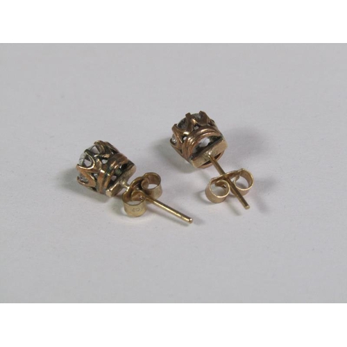 123 - A pair of gold ear studs, each coronet set with a cut diamond, each approx. 0.5ct.