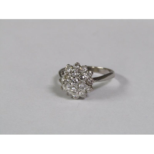 128 - An 18ct white gold set diamond cluster set ring.