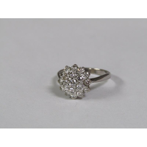 128 - An 18ct white gold set diamond cluster set ring.