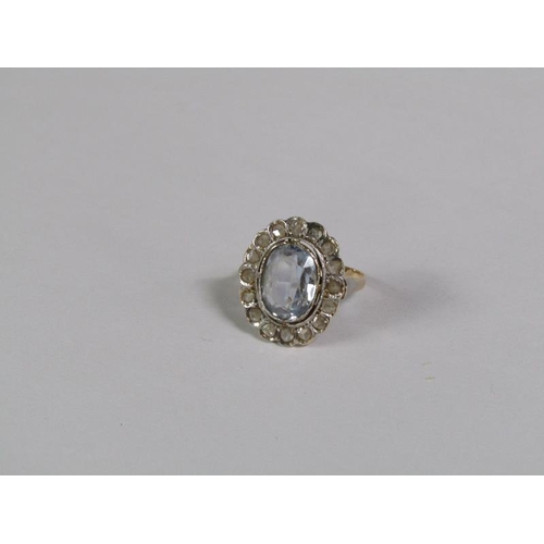 129 - A gold aquamarine and diamond set ring of oval form with a central oval cut aquamarine surround by a... 