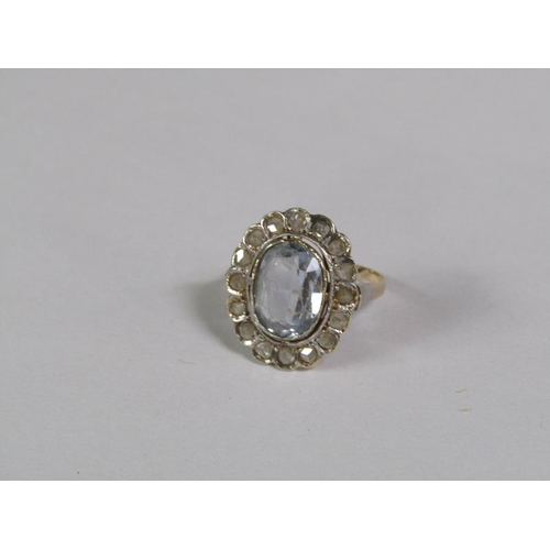 129 - A gold aquamarine and diamond set ring of oval form with a central oval cut aquamarine surround by a... 