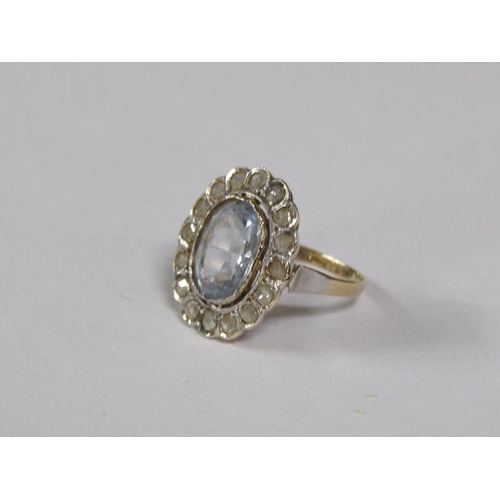 129 - A gold aquamarine and diamond set ring of oval form with a central oval cut aquamarine surround by a... 