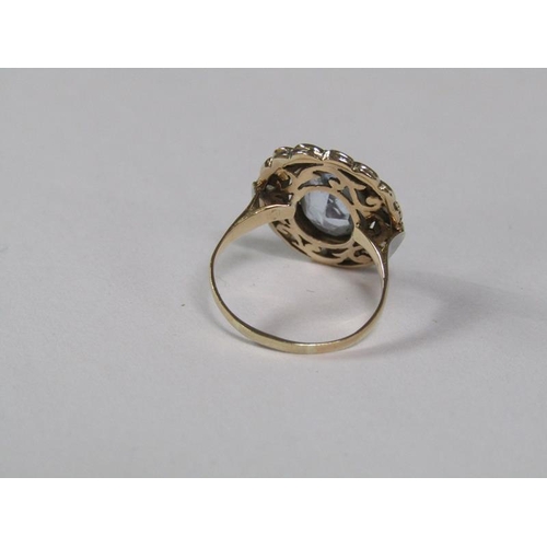 129 - A gold aquamarine and diamond set ring of oval form with a central oval cut aquamarine surround by a... 