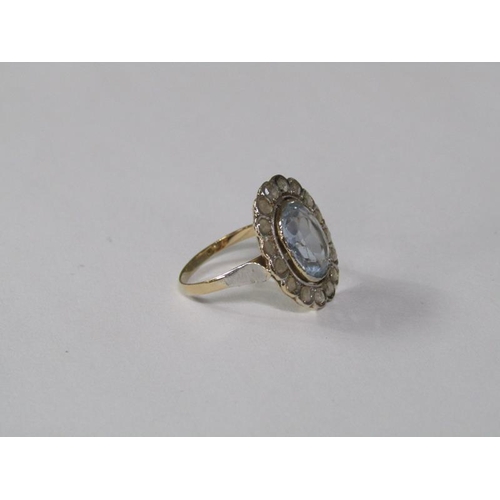 129 - A gold aquamarine and diamond set ring of oval form with a central oval cut aquamarine surround by a... 