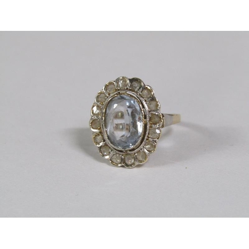 129 - A gold aquamarine and diamond set ring of oval form with a central oval cut aquamarine surround by a... 