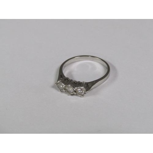 130 - An 18ct white gold three stone diamond set ring.