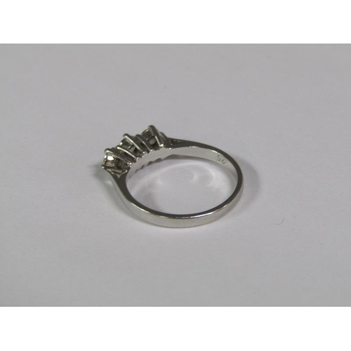 130 - An 18ct white gold three stone diamond set ring.