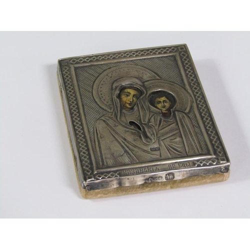 62 - A 19c Russian travelling icon with a Madonna and child within an embossed and chased silver panel, i... 