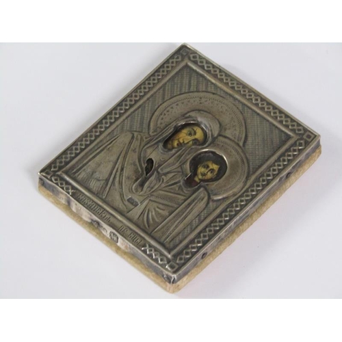 62 - A 19c Russian travelling icon with a Madonna and child within an embossed and chased silver panel, i... 