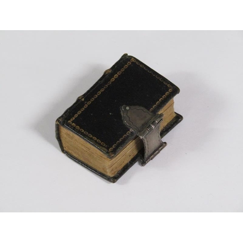 64 - A late 17c German miniature prayer book with embossed leather spine and boards, together with a whit... 