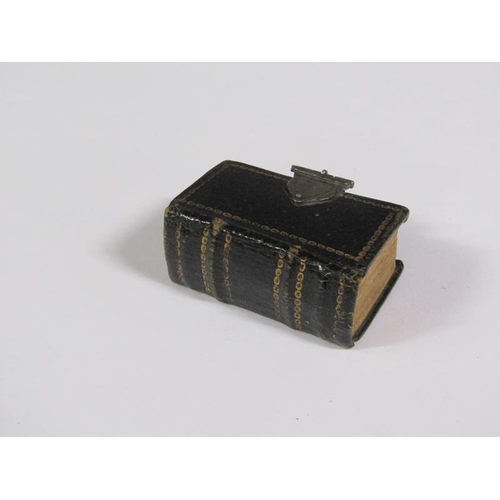 64 - A late 17c German miniature prayer book with embossed leather spine and boards, together with a whit... 