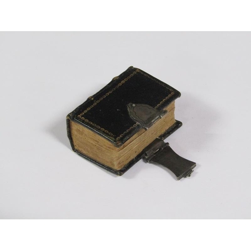 64 - A late 17c German miniature prayer book with embossed leather spine and boards, together with a whit... 