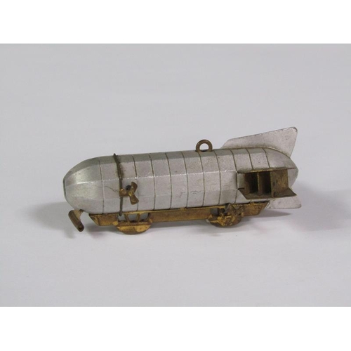 67 - An early 20c novelty tape measure in the form of an airship, silvered and gilt metaled, 8cm l.