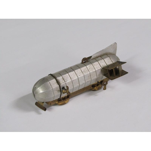 67 - An early 20c novelty tape measure in the form of an airship, silvered and gilt metaled, 8cm l.