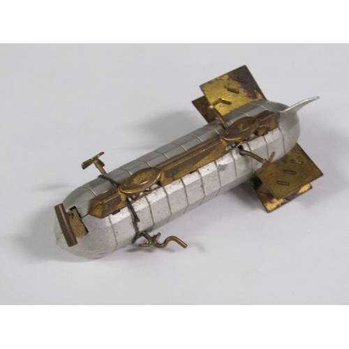 67 - An early 20c novelty tape measure in the form of an airship, silvered and gilt metaled, 8cm l.