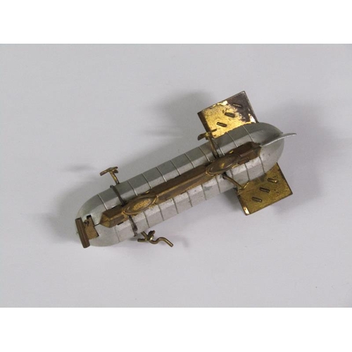 67 - An early 20c novelty tape measure in the form of an airship, silvered and gilt metaled, 8cm l.