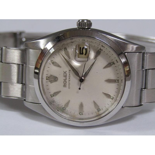 101 - A Rolex Oyster date gentlemen's steel wristwatch with a purchase guarantee dated 8th March 1958 and ... 