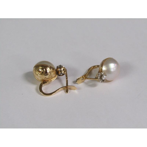 131 - A pair of gold diamond and pearl set earrings.