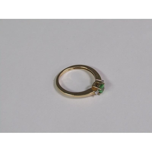 139 - A gold emerald and diamond ring, size O 1/2.