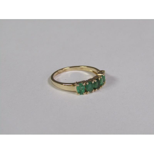 140 - A gold five stone emerald ring, size L 3/4.