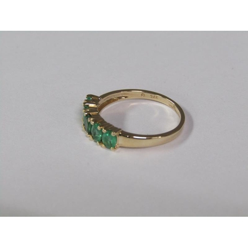 140 - A gold five stone emerald ring, size L 3/4.