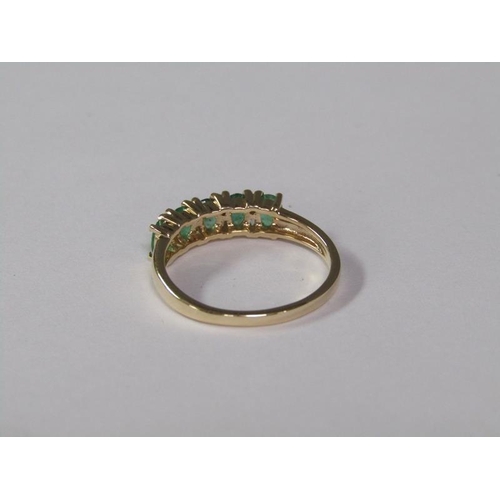 140 - A gold five stone emerald ring, size L 3/4.