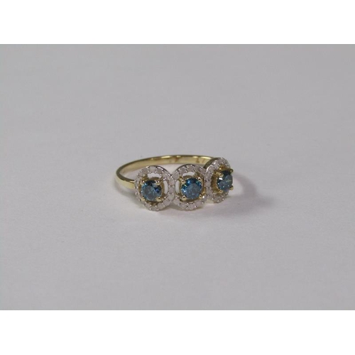 142 - A gold blue and white diamond three stone set ring, size K.