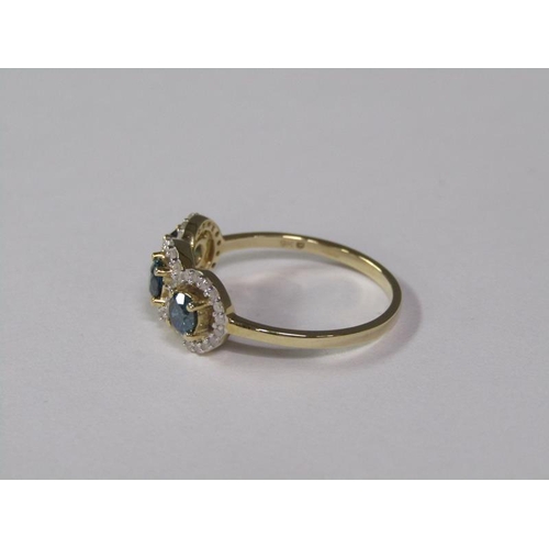 142 - A gold blue and white diamond three stone set ring, size K.