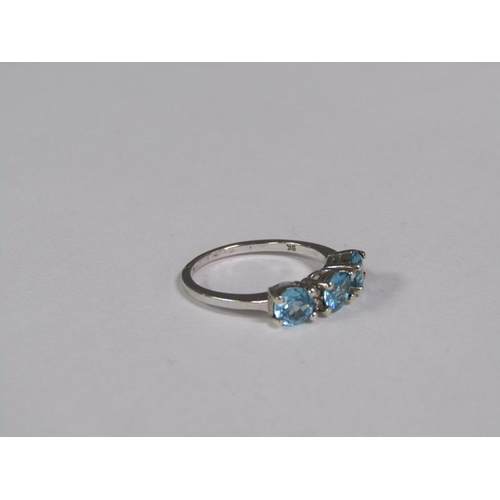 145 - A gold blue zircon and diamond three stone set ring, size J 1/2.