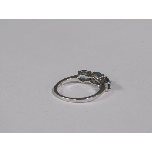 145 - A gold blue zircon and diamond three stone set ring, size J 1/2.