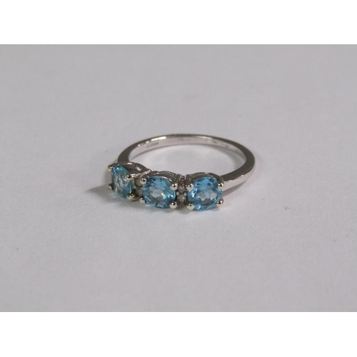 145 - A gold blue zircon and diamond three stone set ring, size J 1/2.