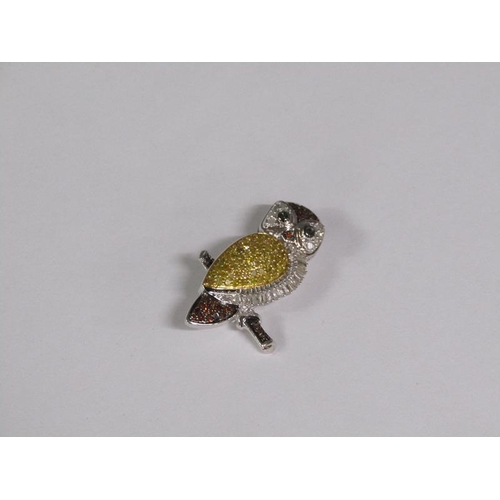 146 - A fancy diamond owl brooch.