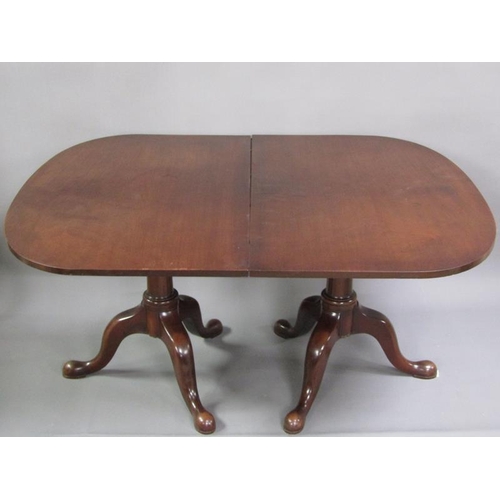 320 - A George III mahogany twin pedestal D end dining table with one extra leaf, each pedestal has three ... 