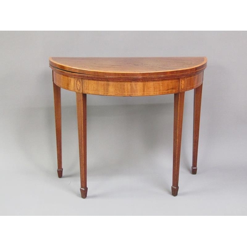 331 - A late Regency mahogany demi lune fold over card table, crossbanded and line inlaid with a deep frie... 