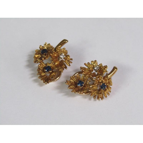 133 - A pair of 18ct gold leaf formed diamond and sapphire set clip earrings.