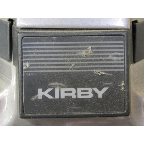 335 - KIRBY VACUUM CLEANER, ACCESSORIES, AND A SEWING MACHINE ETC.