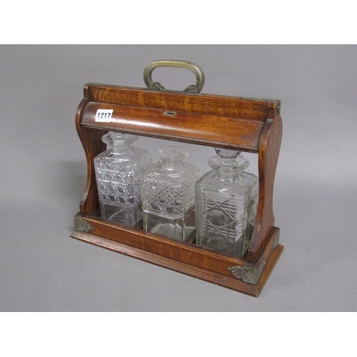 1217 - EARLY 20C EDWARDIAN OAK THREE BOTTLE TANTALUS, TWO BOTTLES A/F, 36CM W AT BASE